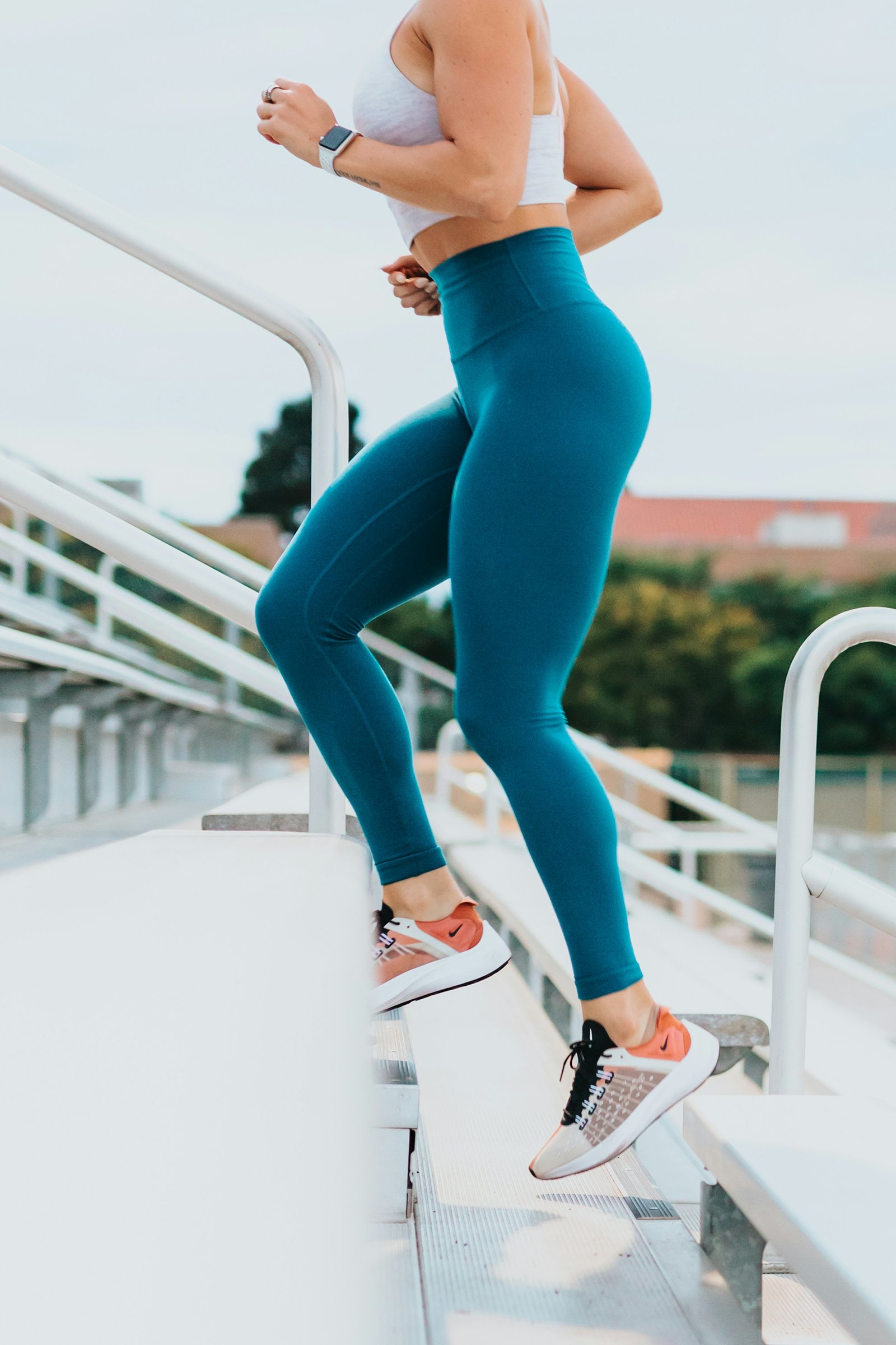 Runner climbing outdoor stadium stairs
